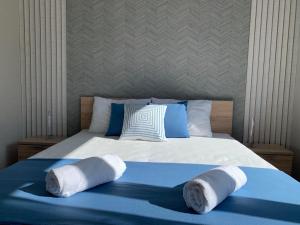 a bedroom with a bed with towels on it at BL Residence Balatonlelle in Balatonlelle +27 photos