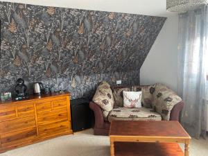 a living room with a couch and a table at Lochview Guest House in Ullapool +32 photos