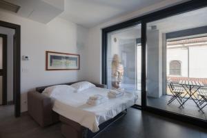 a bedroom with a bed and a large window at Bergamo SottoSopra Gold in Bergamo