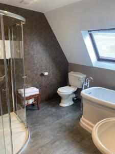 a bathroom with a shower and a toilet and a sink at Lochview Guest House in Ullapool