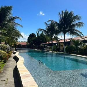 a swimming pool with a bird in the water at Casa Bela in Itamaracá