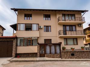 a large building with windows and a balcony at Emara Lodge Bansko in Bansko