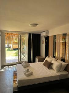 a bedroom with a large bed with towels on it at Mistral Alaçatı Hotel in Çeşme