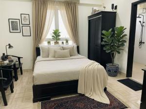a bedroom with a large bed with a black headboard at Muse Riverside in Ninh Binh