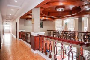a hallway with a staircase in a building at Ha Trinh Hotel in Bien Hoa