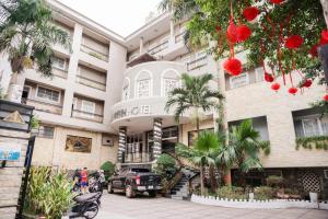 a building with a car parked in front of it at Ha Trinh Hotel in Bien Hoa