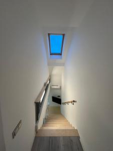 a staircase in a building with a skylight at Apartments ,,Morena'' Melnragė in Melnragė