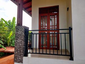 a red door on a house with a fence at Skyline Residence in Wadduwa