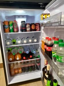 an open refrigerator filled with lots of drinks and drinks at Affordable Staycation at Azure Urban Resort Residences Near NAIA in Manila