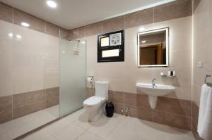 a bathroom with a toilet and a sink at Elyasmene in Qinā +18 photos