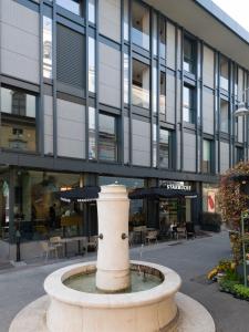 a water fountain in front of a building at Bergamo SottoSopra Gold in Bergamo
