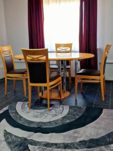 a dining room with a wooden table and chairs at Apartments by Pension Pale Bach in Bad Hersfeld