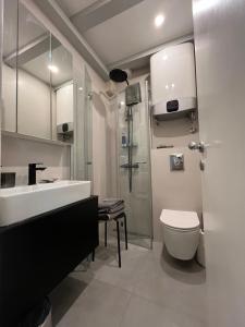 a bathroom with a sink and a toilet and a shower at Cozy Old Town Interlude Apartment in Dubrovnik +29 photos