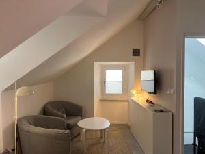 a living room with a chair and a table at Cozy Old Town Interlude Apartment in Dubrovnik