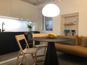 a kitchen and a table with a bowl of fruit on it at Cozy Old Town Interlude Apartment in Dubrovnik