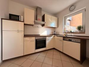 a kitchen with white appliances and a window at Auszeit in Bad Sobernheim +6 photos