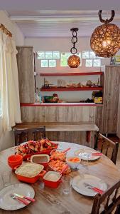 a table with plates of food on top of it at Piaça House - Piaçaguera -Pr in Paranaguá
