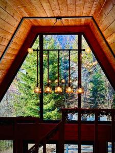 a large window in a room with a chandelier at Twin Cabins Azuga in Azuga