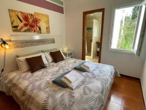 a bedroom with a bed with three pillows on it at Casa Dieter-air conditioning is not included in Cala Galdana +40 photos