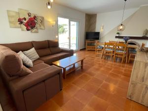 a living room with a couch and a table at Casa Dieter-air conditioning is not included in Cala Galdana
