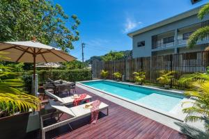 a backyard with a swimming pool and an umbrella at Siya Private Pool Villa Ao Nang in Ao Nang Beach
