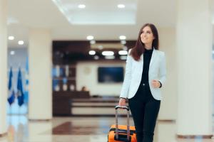 a woman is pulling a suitcase in an airport at Egypt Pyramids Hotel in Cairo