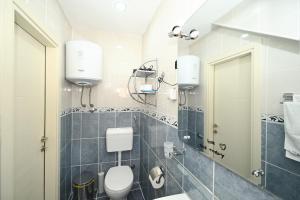 a bathroom with a toilet and a mirror at Old town central in Kotor +62 photos