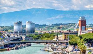 a city with a bridge over a river with boats at Credo Mare Luxury Stay - Comfort in Pescara