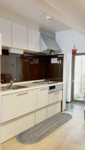 a kitchen with white cabinets and a sink at 嵐lan in Kyoto