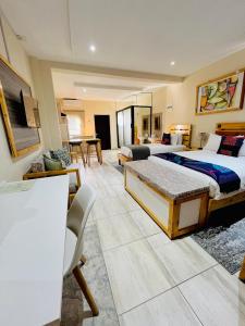 a bedroom with two beds and a living room at Thabeng Hotel & Restaurant in Maseru