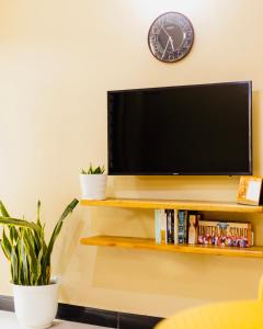 a flat screen tv sitting on top of a shelf at Sakina Nook in Arusha +7 photos