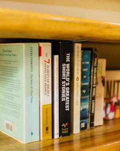 a row of books sitting on a shelf at Sakina Nook in Arusha