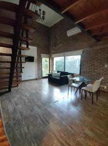 a living room with a table and a couch at Las Arecas in Carmen de Areco