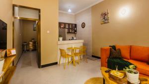 a living room with a couch and a table at Sakina Nook in Arusha
