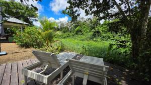 a table and chairs sitting on a wooden deck at Parakreek Apartments in Boxel