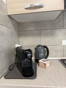 a coffee maker and a tea kettle on a counter at Via Veneto in Loreto Aprutino +6 photos