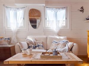 a living room with a couch and a coffee table at L'authentique chalet en bois sur pilotis in Gruissan