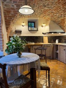 a kitchen with a table and chairs and a table and a counter at Czerwony Dworek 8 - Agroturystyka Karkonosze in Mysłakowice