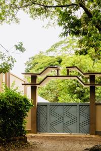 a garage door with a gate with a hill in the background at Sakina Nook in Arusha