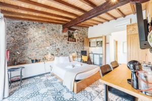a bedroom with a bed and a table in a room at Villas de Cintra in Sintra