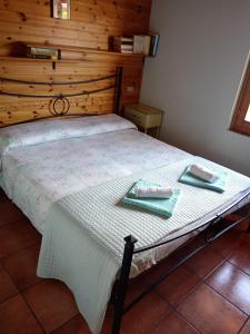 a bedroom with a bed with two plates on it at Holiday home Désirée in Sorico