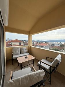 a balcony with a couch and chairs and a table at House 23 B1 in Tivat