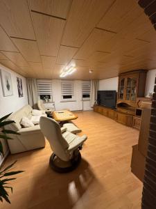 a living room with a couch and a table at Bergmannsruh OG in Clausthal-Zellerfeld
