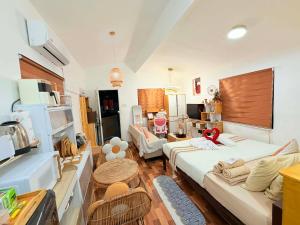 a living room with a couch and a table at Olango Island-Tiny Guest House Fully Furnished with Hot Shower, Washer, Wi-Fi, Netflix & King Bed S&E-3 in Lapu Lapu City