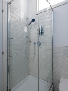 a bathroom with a shower with a glass door at Bergamo Sottosopra in Bergamo +44 photos