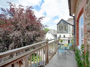 a balcony with two chairs and a table at Tuckenhay, Mill Stream - Fme in Ashsprington +34 photos