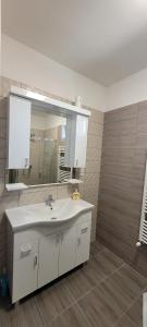 a bathroom with a sink and a mirror at Arany-Lak Hajdúszoboszló in Hajdúszoboszló