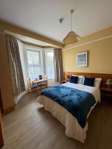 a bedroom with a large bed and a table and chairs at ABC House in Dublin