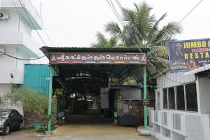 an entrance to a building with a sign on it at Sri Kalki Jamjam Resort in Erode