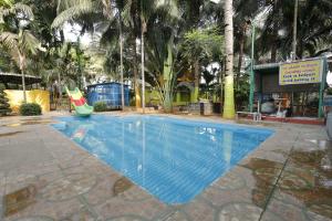 a swimming pool with a slide in a resort at Sri Kalki Jamjam Resort in Erode